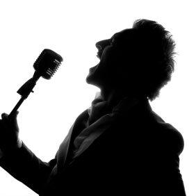 Man posing and singing in studio